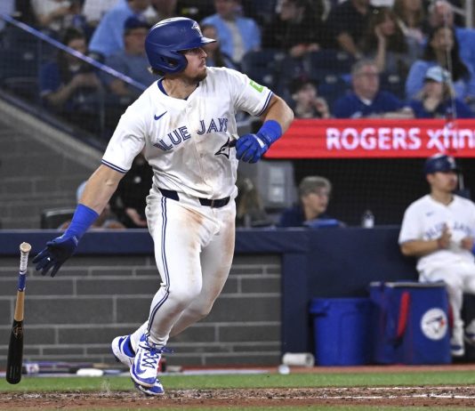 Toronto Blue Jays third baseman Addison Barger runs out a single against the Tampa Bay Rays in fifth inning baseball action in Toronto on Wednesday, May 14, 2025. (Jon Blacker/The Canadian Press via AP)