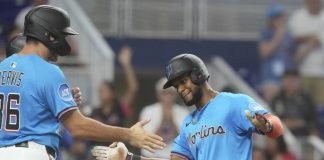 Miami Marlins' Otto Lopez, right, celebrates with Matt Mervis, left, after hitting a three-run home run during the fourth inning of a baseball game against the Tampa Bay Rays, Sunday, May 18, 2025, in Miami. (AP Photo/Marta Lavandier)