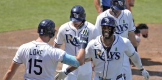 Tampa Bay Rays' Yandy DÌaz, right, celebrates with teammates, including Josh Lowe, left, after Diaz hit a three-run home run off Houston Astros Forrest Whitley during the eighth inning of a baseball game Wednesday, May 21, 2025, in Tampa, Fla. (AP Photo/Chris O'Meara)