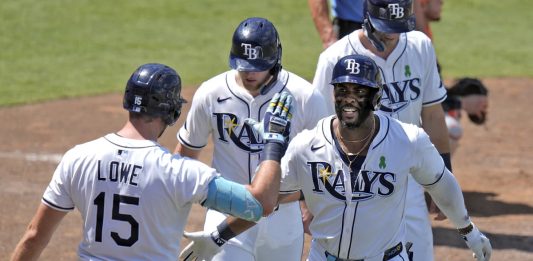 Tampa Bay Rays' Yandy DÌaz, right, celebrates with teammates, including Josh Lowe, left, after Diaz hit a three-run home run off Houston Astros Forrest Whitley during the eighth inning of a baseball game Wednesday, May 21, 2025, in Tampa, Fla. (AP Photo/Chris O'Meara)