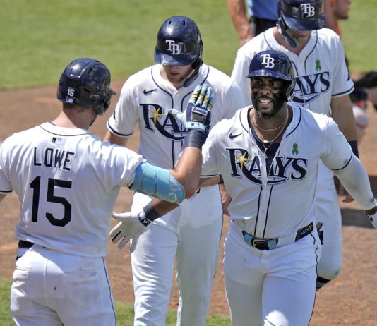 Tampa Bay Rays' Yandy DÌaz, right, celebrates with teammates, including Josh Lowe, left, after Diaz hit a three-run home run off Houston Astros Forrest Whitley during the eighth inning of a baseball game Wednesday, May 21, 2025, in Tampa, Fla. (AP Photo/Chris O'Meara)