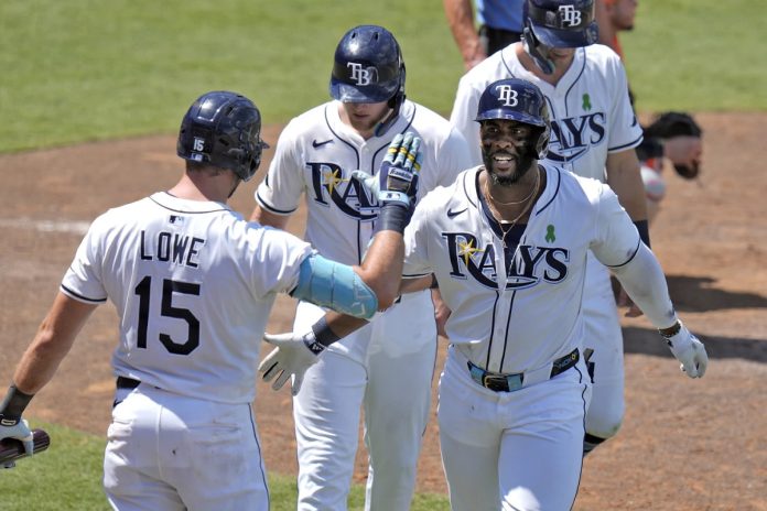Rays Defeat Astros 8-4 Tampa Bay Rays' Yandy DÌaz, right, celebrates with teammates, including Josh Lowe, left, after Diaz hit a three-run home run off Houston Astros Forrest Whitley during the eighth inning of a baseball game Wednesday, May 21, 2025, in Tampa, Fla. (AP Photo/Chris O'Meara)