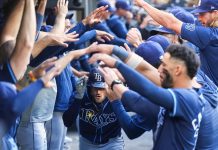 Tampa Bay Rays' Brandon Lowe, center, is greeted in the dugout after hitting a two-run home run in the ninth inning of a baseball game against the Toronto Blue Jays in Toronto, Thursday, May 15, 2025. (Nathan Denette/The Canadian Press via AP)