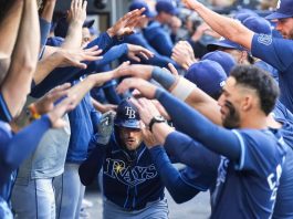 Tampa Bay Rays' Brandon Lowe, center, is greeted in the dugout after hitting a two-run home run in the ninth inning of a baseball game against the Toronto Blue Jays in Toronto, Thursday, May 15, 2025. (Nathan Denette/The Canadian Press via AP)