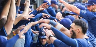 Tampa Bay Rays' Brandon Lowe, center, is greeted in the dugout after hitting a two-run home run in the ninth inning of a baseball game against the Toronto Blue Jays in Toronto, Thursday, May 15, 2025. (Nathan Denette/The Canadian Press via AP)