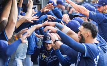 Tampa Bay Rays' Brandon Lowe, center, is greeted in the dugout after hitting a two-run home run in the ninth inning of a baseball game against the Toronto Blue Jays in Toronto, Thursday, May 15, 2025. (Nathan Denette/The Canadian Press via AP)