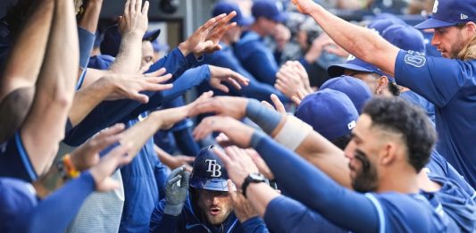 Tampa Bay Rays' Brandon Lowe, center, is greeted in the dugout after hitting a two-run home run in the ninth inning of a baseball game against the Toronto Blue Jays in Toronto, Thursday, May 15, 2025. (Nathan Denette/The Canadian Press via AP)