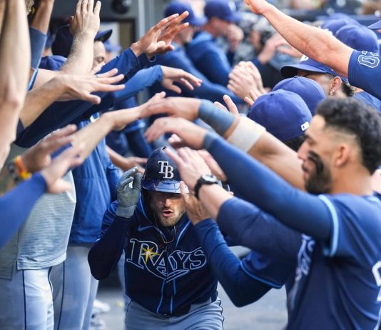 Tampa Bay Rays' Brandon Lowe, center, is greeted in the dugout after hitting a two-run home run in the ninth inning of a baseball game against the Toronto Blue Jays in Toronto, Thursday, May 15, 2025. (Nathan Denette/The Canadian Press via AP)