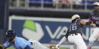 Tampa Bay Rays' Yandy Díaz (2) as Miami Marlins short stop Javier Sanoja (46) is late with the tags during the first inning of a baseball game, Saturday, May 17, 2025, in Miami. (AP Photo/Marta Lavandier)
