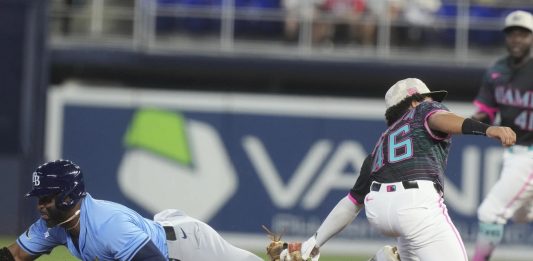 Tampa Bay Rays' Yandy Díaz (2) as Miami Marlins short stop Javier Sanoja (46) is late with the tags during the first inning of a baseball game, Saturday, May 17, 2025, in Miami. (AP Photo/Marta Lavandier)