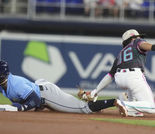 Tampa Bay Rays' Yandy Díaz (2) as Miami Marlins short stop Javier Sanoja (46) is late with the tags during the first inning of a baseball game, Saturday, May 17, 2025, in Miami. (AP Photo/Marta Lavandier)