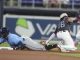Tampa Bay Rays' Yandy Díaz (2) as Miami Marlins short stop Javier Sanoja (46) is late with the tags during the first inning of a baseball game, Saturday, May 17, 2025, in Miami. (AP Photo/Marta Lavandier)