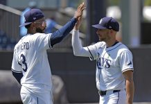 Tampa Bay Rays' Junior Caminero (13) and Brandon Lowe celebrate after the team defeated the Minnesota Twins during a baseball game Wednesday, May 28, 2025, in Tampa, Fla. (AP Photo/Chris O'Meara)