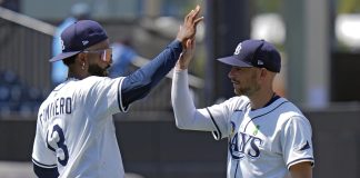 Tampa Bay Rays' Junior Caminero (13) and Brandon Lowe celebrate after the team defeated the Minnesota Twins during a baseball game Wednesday, May 28, 2025, in Tampa, Fla. (AP Photo/Chris O'Meara)