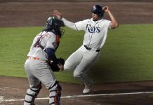 Tampa Bay Rays' Christopher Morel scores the game-winning run in front of Houston Astros catcher Victor Caratini on a sacrifice fly by Taylor Walls during the ninth inning of a baseball game Tuesday, May 20, 2025, in Tampa, Fla. (AP Photo/Chris O'Meara)