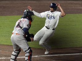 Tampa Bay Rays' Christopher Morel scores the game-winning run in front of Houston Astros catcher Victor Caratini on a sacrifice fly by Taylor Walls during the ninth inning of a baseball game Tuesday, May 20, 2025, in Tampa, Fla. (AP Photo/Chris O'Meara)