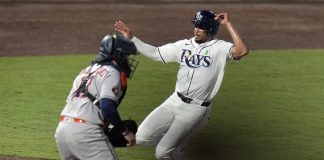 Tampa Bay Rays' Christopher Morel scores the game-winning run in front of Houston Astros catcher Victor Caratini on a sacrifice fly by Taylor Walls during the ninth inning of a baseball game Tuesday, May 20, 2025, in Tampa, Fla. (AP Photo/Chris O'Meara)
