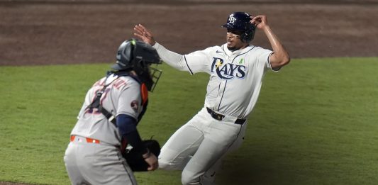 Tampa Bay Rays' Christopher Morel scores the game-winning run in front of Houston Astros catcher Victor Caratini on a sacrifice fly by Taylor Walls during the ninth inning of a baseball game Tuesday, May 20, 2025, in Tampa, Fla. (AP Photo/Chris O'Meara)