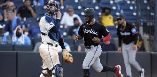Miami Marlins' Otto Lopez scores in front of Tampa Bay Rays catcher Danny Jansen on an RBI single by Heriberto Hernandez off pitcher Garrett Cleavinger during the 10th inning of a baseball game Saturday, June 7, 2025, in Tampa, Fla. (AP Photo/Chris O'Meara)