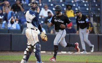 Miami Marlins' Otto Lopez scores in front of Tampa Bay Rays catcher Danny Jansen on an RBI single by Heriberto Hernandez off pitcher Garrett Cleavinger during the 10th inning of a baseball game Saturday, June 7, 2025, in Tampa, Fla. (AP Photo/Chris O'Meara)