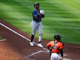 Tampa Bay Rays' Yandy Diaz, left, celebrates his three-run home run during the fourth inning of a baseball game as Baltimore Orioles catcher Chadwick Tromp looks on at right, Saturday, June 28, 2025, in Baltimore. (AP Photo/Nick Wass)