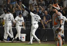 Tampa Bay Rays' Josh Lowe (15) and Junior Caminero (13) celebrate after scoring on a Jonathan Aranda single during the seventh inning of a baseball game against the Baltimore Orioles, Wednesday, June 18, 2025, in Tampa, Fla. (AP Photo/Jason Behnken)