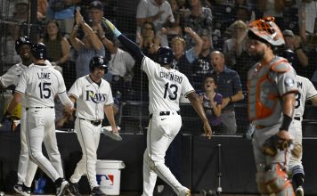 Tampa Bay Rays' Josh Lowe (15) and Junior Caminero (13) celebrate after scoring on a Jonathan Aranda single during the seventh inning of a baseball game against the Baltimore Orioles, Wednesday, June 18, 2025, in Tampa, Fla. (AP Photo/Jason Behnken)
