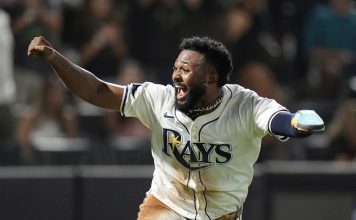Tampa Bay Rays' Junior Caminero reacts after scoring the game-winning run on an RBI single by Taylor Walls off Texas Rangers pitcher Robert Garcia during the ninth inning of a baseball game Thursday, June 5, 2025, in Tampa, Fla. (AP Photo/Chris O'Meara)