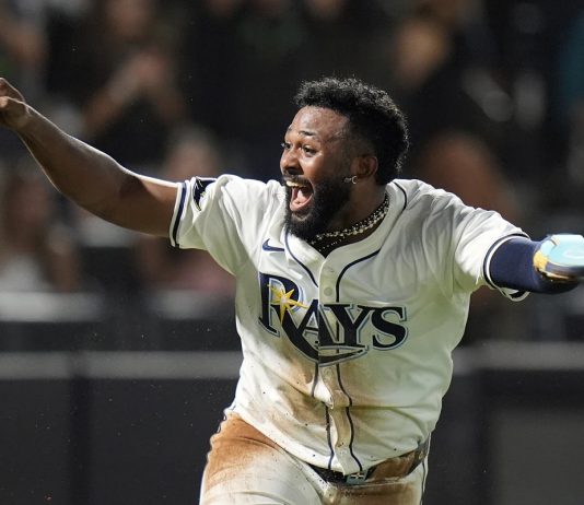 Tampa Bay Rays' Junior Caminero reacts after scoring the game-winning run on an RBI single by Taylor Walls off Texas Rangers pitcher Robert Garcia during the ninth inning of a baseball game Thursday, June 5, 2025, in Tampa, Fla. (AP Photo/Chris O'Meara)