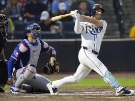 Tampa Bay Rays' Brandon Lowe watches his RBI double off Texas Rangers pitcher Kumar Rocker during the third inning of a baseball game Wednesday, June 4, 2025, in Tampa, Fla. (AP Photo/Chris O'Meara)
