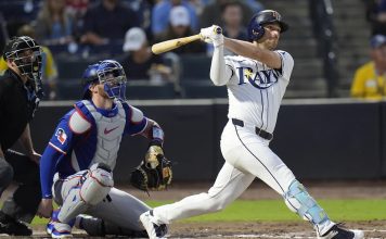 Tampa Bay Rays' Brandon Lowe watches his RBI double off Texas Rangers pitcher Kumar Rocker during the third inning of a baseball game Wednesday, June 4, 2025, in Tampa, Fla. (AP Photo/Chris O'Meara)