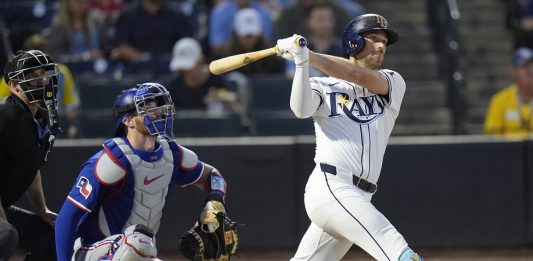 Tampa Bay Rays' Brandon Lowe watches his RBI double off Texas Rangers pitcher Kumar Rocker during the third inning of a baseball game Wednesday, June 4, 2025, in Tampa, Fla. (AP Photo/Chris O'Meara)