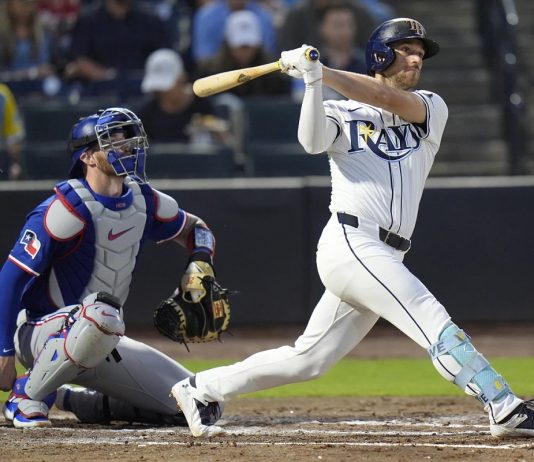 Tampa Bay Rays' Brandon Lowe watches his RBI double off Texas Rangers pitcher Kumar Rocker during the third inning of a baseball game Wednesday, June 4, 2025, in Tampa, Fla. (AP Photo/Chris O'Meara)
