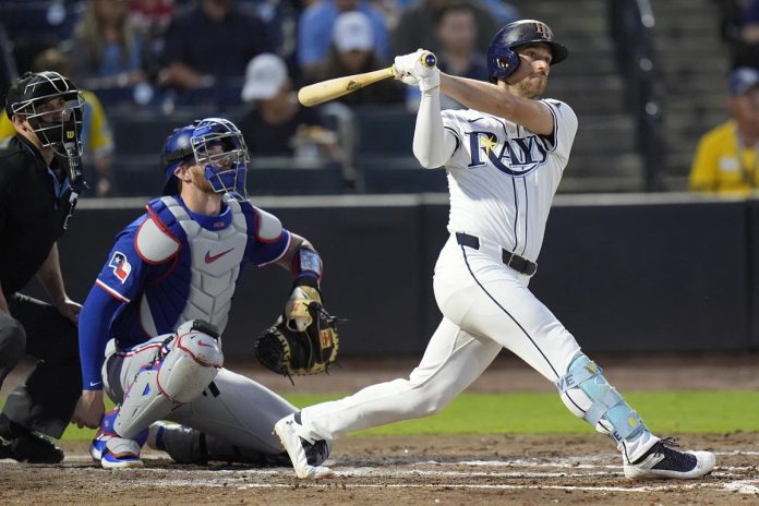 Tampa Bay Rays' Brandon Lowe watches his RBI double off Texas Rangers pitcher Kumar Rocker during the third inning of a baseball game Wednesday, June 4, 2025, in Tampa, Fla. (AP Photo/Chris O'Meara)