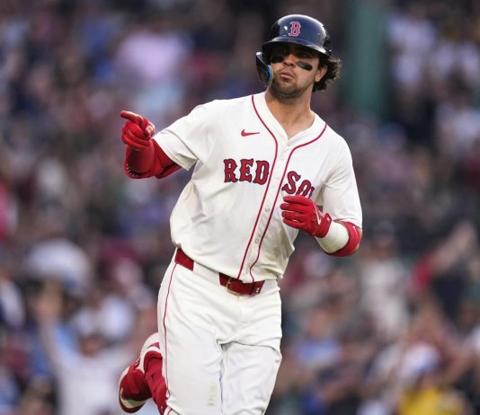 Boston Red Sox's Marcelo Mayer points towards the Red Sox dugout while rounding the bases on his solo home run during the second inning of a baseball game against the Tampa Bay Rays at Fenway Park, Wednesday, June 11, 2025, in Boston. (AP Photo/Charles Krupa)