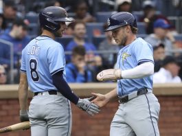 Tampa Bay Rays' Brandon Lowe, left, and Taylor Walls, right, react after Walls scored on a single hit by Josh Lowe during the third inning of a baseball game against the New York Mets Saturday, June 14, 2025, in New York. (AP Photo/Pamela Smith)