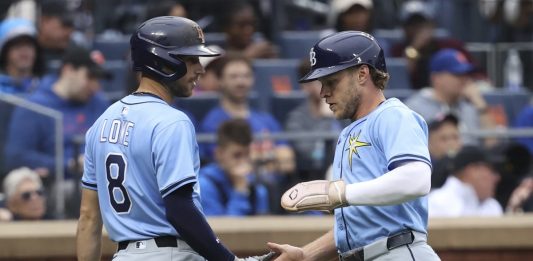 Tampa Bay Rays' Brandon Lowe, left, and Taylor Walls, right, react after Walls scored on a single hit by Josh Lowe during the third inning of a baseball game against the New York Mets Saturday, June 14, 2025, in New York. (AP Photo/Pamela Smith)