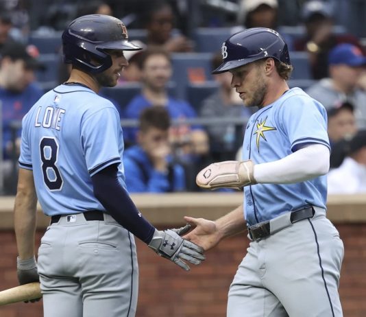 Tampa Bay Rays' Brandon Lowe, left, and Taylor Walls, right, react after Walls scored on a single hit by Josh Lowe during the third inning of a baseball game against the New York Mets Saturday, June 14, 2025, in New York. (AP Photo/Pamela Smith)