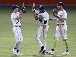 Tampa Bay Rays outfielders Jake Mangum, left, Chandler Simpson and Josh Lowe, right, celebrate their win against the Baltimore Orioles in a baseball game, Saturday, July 19, 2025, in Tampa, Fla. (AP Photo/Phelan M. Ebenhack)