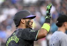 Tampa Bay Rays' José Caballero celebrates after running to third base on a Chicago White Sox error after his single during the second inning of a baseball game Tuesday, July 22, 2025, in Tampa, Fla. (AP Photo/Jason Behnken)