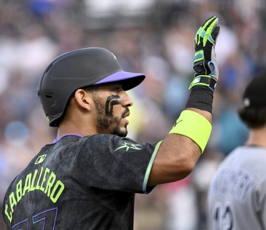 Tampa Bay Rays' José Caballero celebrates after running to third base on a Chicago White Sox error after his single during the second inning of a baseball game Tuesday, July 22, 2025, in Tampa, Fla. (AP Photo/Jason Behnken)