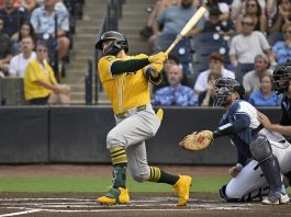 Athletics' Shea Langeliers hits a three-run home run during the first inning of a baseball game against the Tampa Bay Rays, Monday, June 30, 2025, in Tampa, Fla. (AP Photo/Jason Behnken)