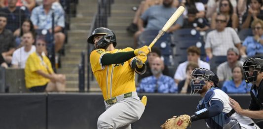 Athletics' Shea Langeliers hits a three-run home run during the first inning of a baseball game against the Tampa Bay Rays, Monday, June 30, 2025, in Tampa, Fla. (AP Photo/Jason Behnken)