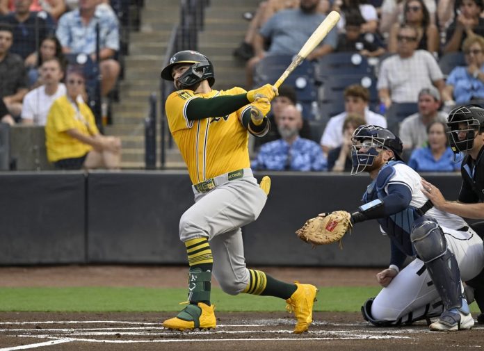 Athletics' Shea Langeliers hits a three-run home run during the first inning of a baseball game against the Tampa Bay Rays, Monday, June 30, 2025, in Tampa, Fla. (AP Photo/Jason Behnken)