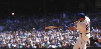 Seattle Mariners designated hitter Cal Raleigh hits a two-run home run against the Tampa Bay Rays during the first inning of a baseball game Sunday, Aug. 10, 2025, in Seattle. (AP Photo/Lindsey Wasson)