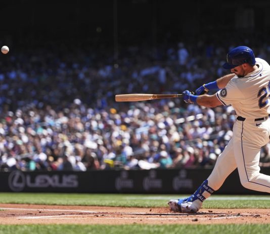 Seattle Mariners designated hitter Cal Raleigh hits a two-run home run against the Tampa Bay Rays during the first inning of a baseball game Sunday, Aug. 10, 2025, in Seattle. (AP Photo/Lindsey Wasson)