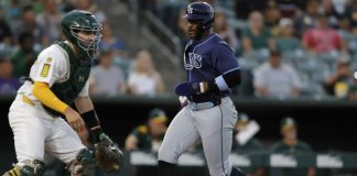 Tampa Bay Rays’ Yandy Diaz, right, scores during the third inning of a baseball game against the Athletics, Monday, Aug. 11, 2025, in West Sacramento, Calif. (AP Photo/Sergio Estrada)