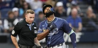 Tampa Bay Rays' Junior Caminero gestures as he crosses home plate with a home run in the fifth inning of a baseball game against the Cleveland Guardians in Cleveland, Monday, Aug. 25, 2025. (AP Photo/Sue Ogrocki)