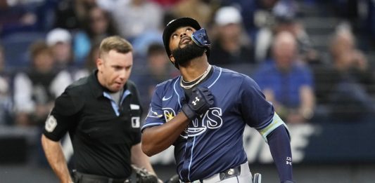 Tampa Bay Rays' Junior Caminero gestures as he crosses home plate with a home run in the fifth inning of a baseball game against the Cleveland Guardians in Cleveland, Monday, Aug. 25, 2025. (AP Photo/Sue Ogrocki)