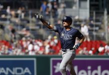 Tampa Bay Rays' Josh Lowe gestures as he runs the bases after hitting a three-run home run against Washington Nationals pitcher Jake Irvin, which scored Brandon Lowe and Junior Caminero, during the first inning of a baseball game, Saturday, Aug. 30, 2025, in Washington. (AP Photo/Terrance Williams)